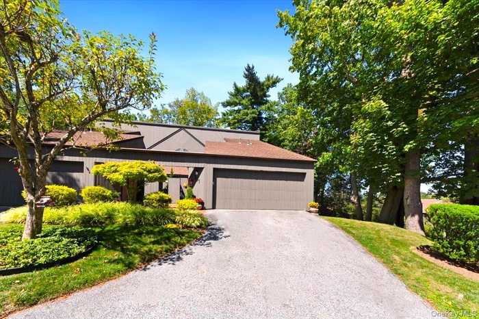 Mid-century modern home with driveway and a garage