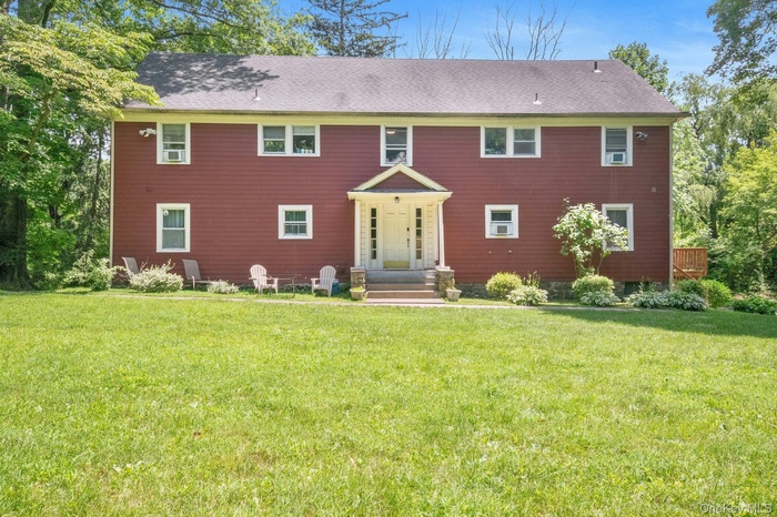 Colonial-style 4 family home (currently a triplex) with front lawn