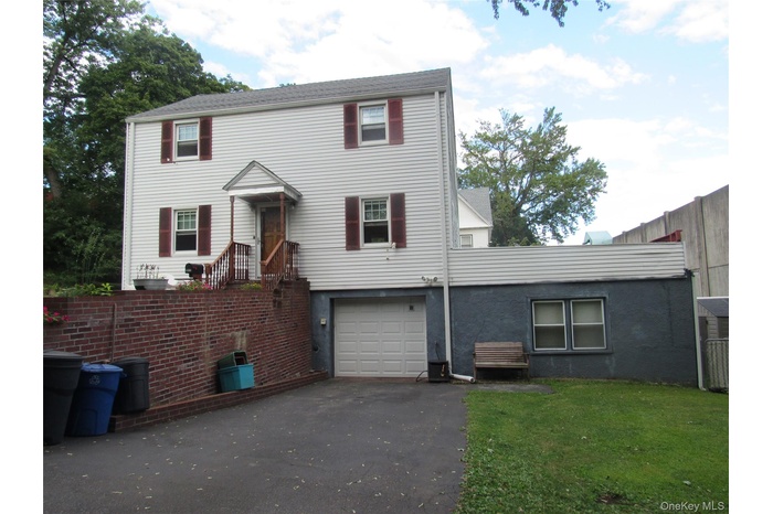 View of front of home with driveway and a garage