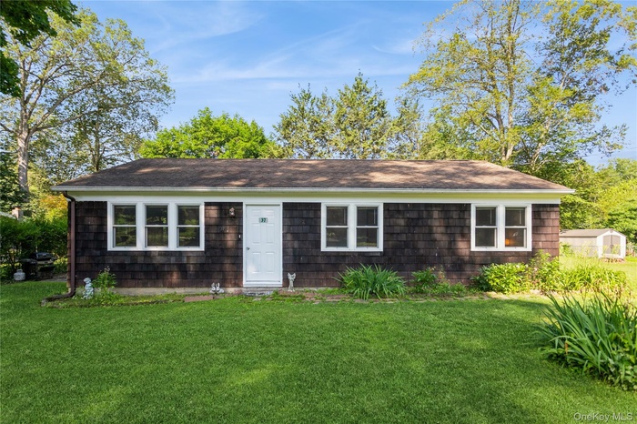 Single story home featuring a front yard