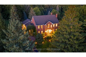 Poised on a serene ravine lot within the prestigious enclave of Manotick Estates, this beautiful Georgian inspired all brick residence embodies distinguished architectural character and timeless elegance.