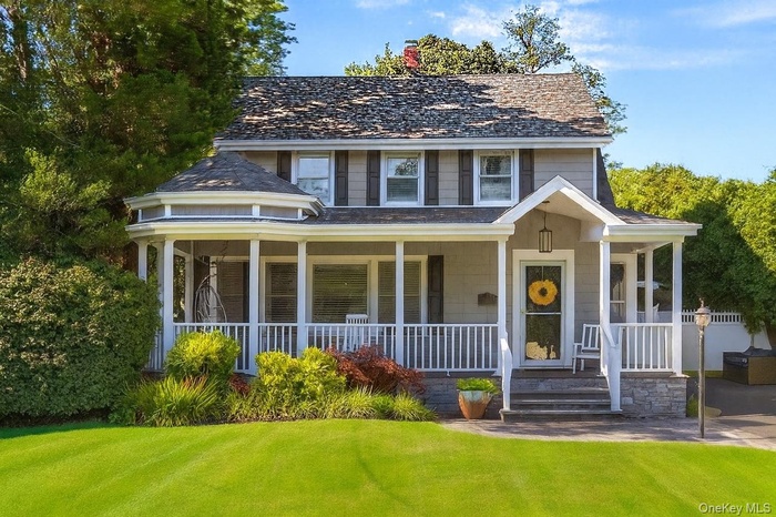 View of front of home featuring a porch and a front yard