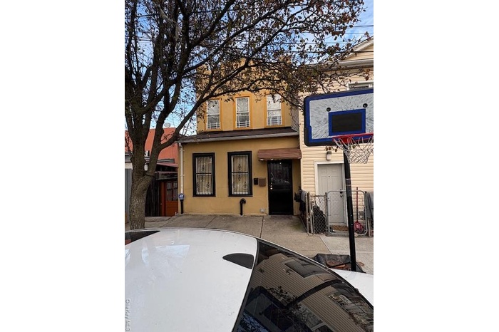 View of front of property with a gate and stucco siding