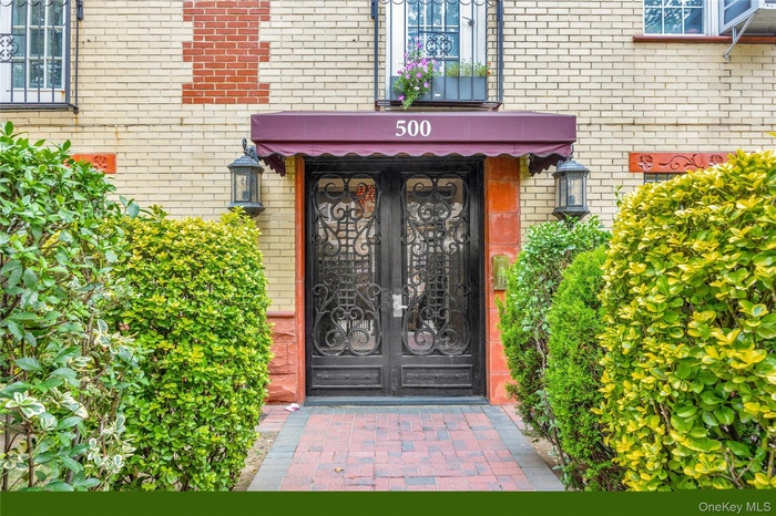 Entrance to property with brick siding