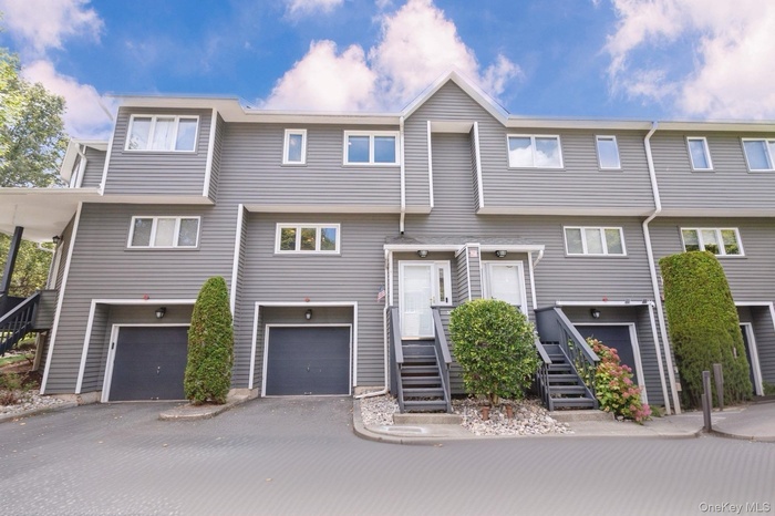 View of front of property with a garage and driveway