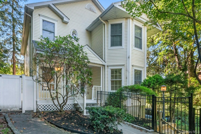 View of front of property featuring a gate and a porch