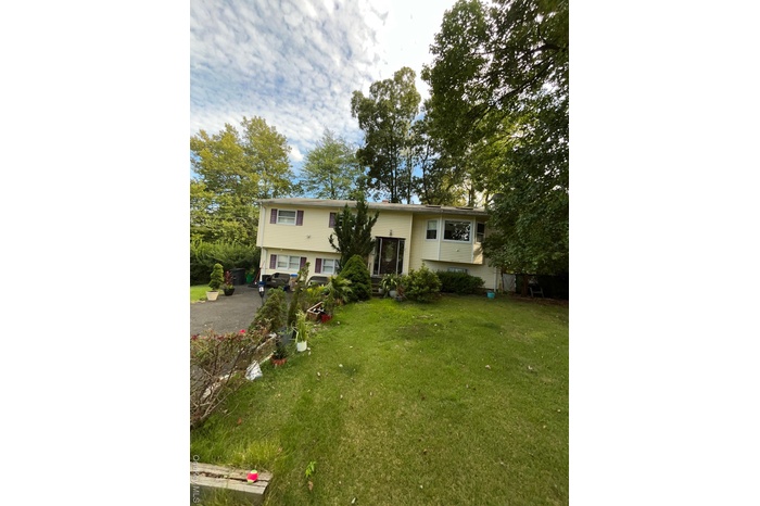 Split foyer home featuring a front yard