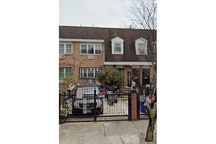 View of front facade with brick siding and a gate