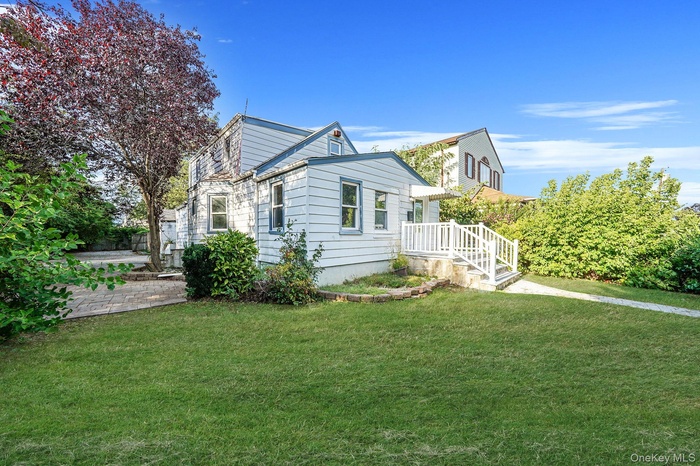 View of side of property with a lawn