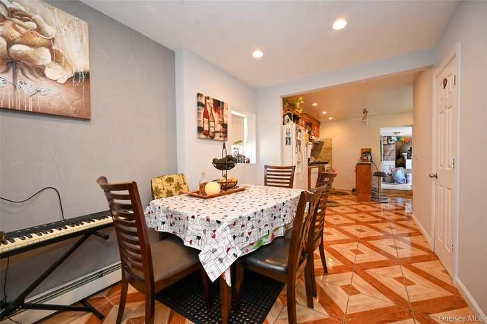 Dining area with recessed lighting and a baseboard heating unit