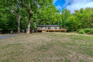 Embrace the charm of this renovated home everything is new from top to bottom 2024 Relax on the 50ft porch that has seasonal views of Big Clear Lake minutes to ...
