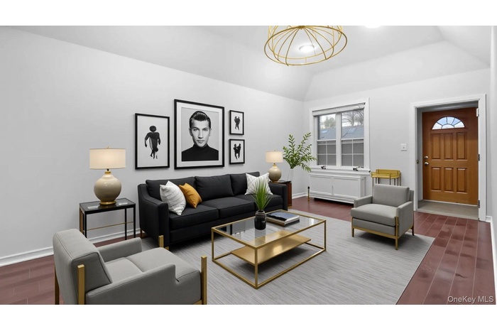 Living room featuring dark wood finished floors and vaulted ceiling