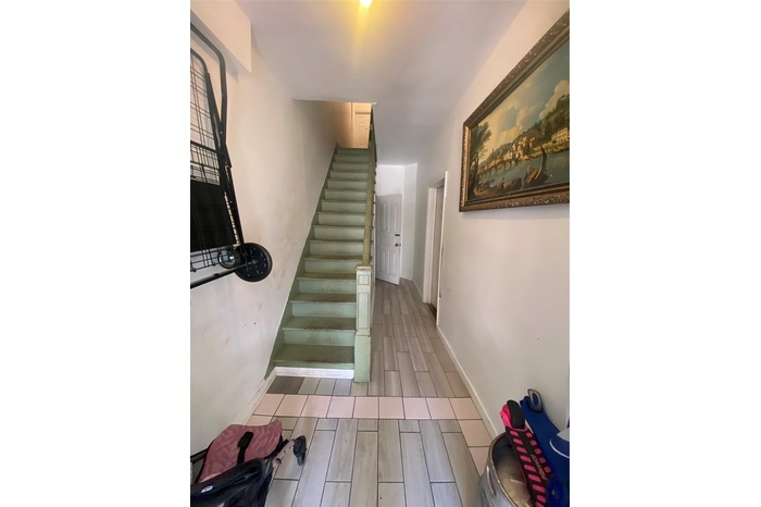 Stairway featuring baseboards and wood tiled floor
