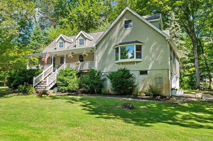 Welcome to 6 Rambler Road — a charming Cape-style retreat tucked away on a private, wooded lot in Lincolndale, NY.