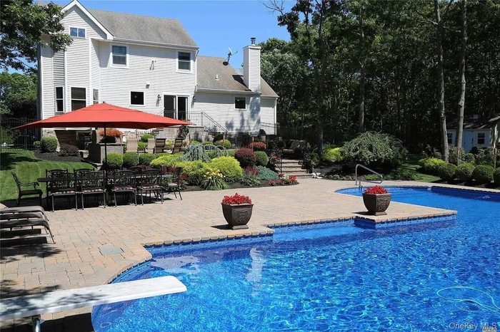 Swimming pool featuring a patio, a diving board, and outdoor dining area