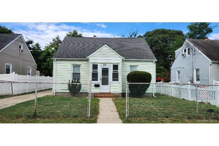 View of front of house featuring a fenced front yard, roof with shingles, and a gate