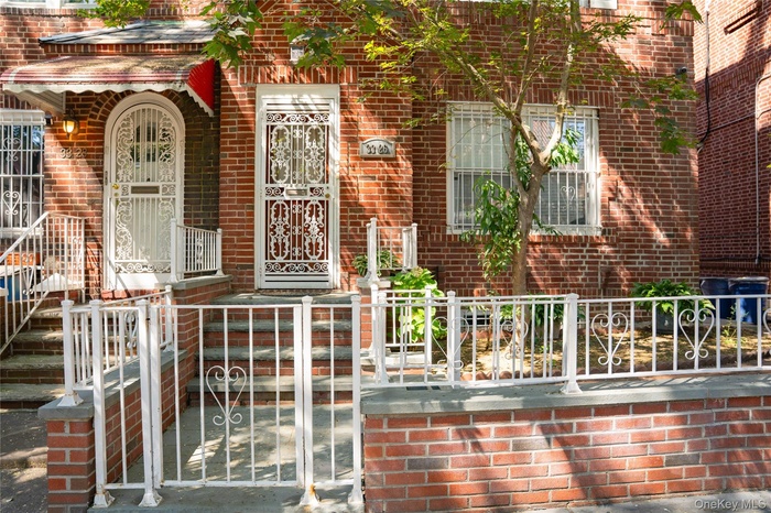 View of exterior entry featuring brick siding