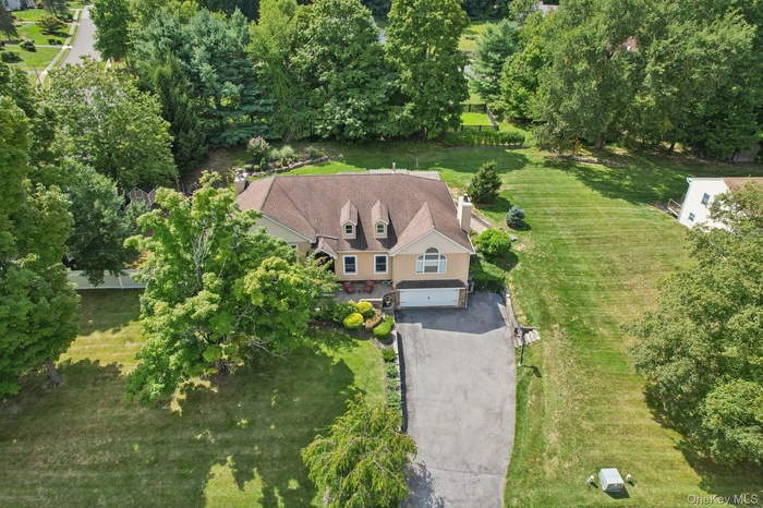 Aerial view of property's location with a tree filled landscape