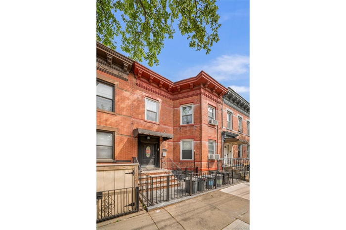 View of building exterior with a fenced front yard