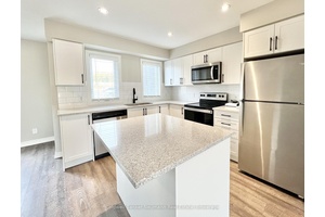 Welcome to 235 Chapel Hill Drive 23, a modern stacked townhome in the desirable Doon South community.