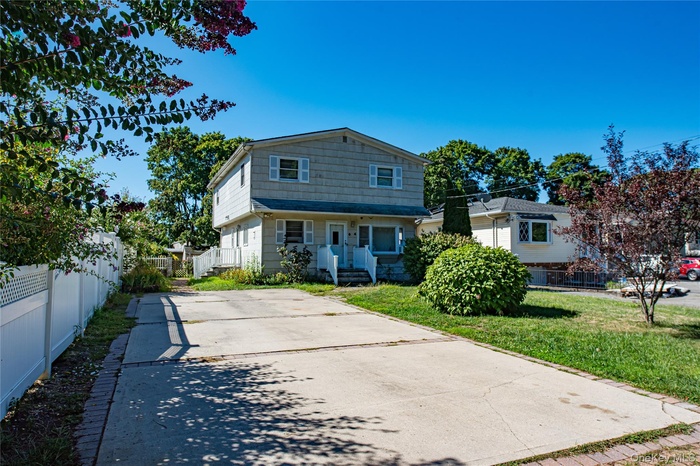 Rear view of property with concrete driveway