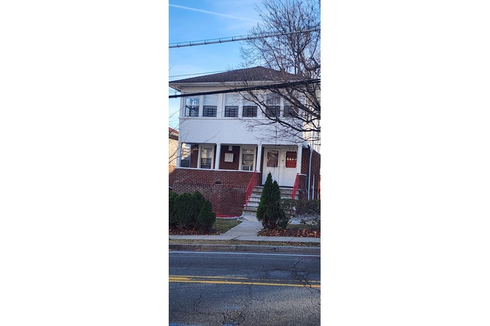 Townhome / multi-family property with a porch