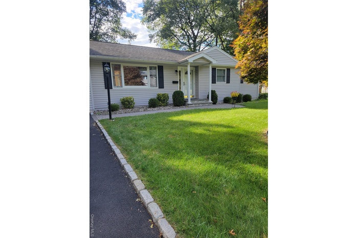 Ranch-style home with a front lawn