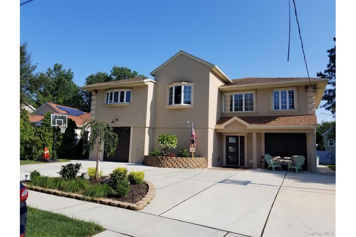 View of front of home featuring an attached garage, stucco siding, and concrete driveway
