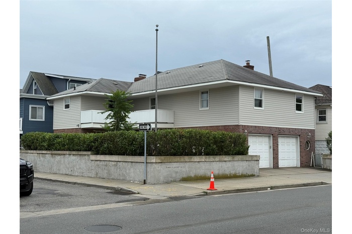 View of property exterior featuring brick siding, an attached garage, and driveway