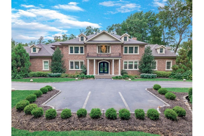 Colonial-style house with brick siding and french doors