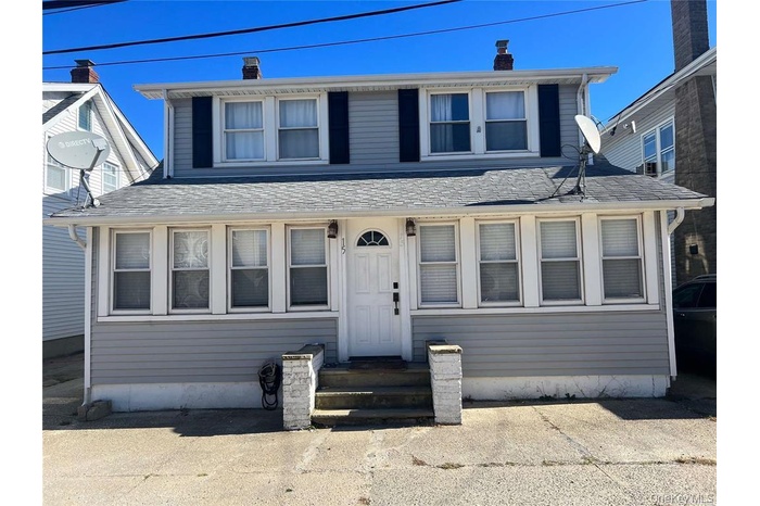 View of front of home featuring a chimney