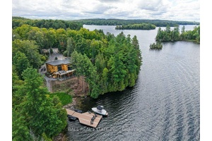 LUXURY LAKEHOUSE One of the most prestigious point lots on Paudash Lake, this stunning 2022 custom built bungalow is tucked in the trees at the end of a year round ...