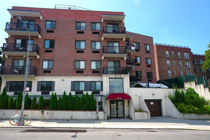 View of apartment building / complex featuring a garage