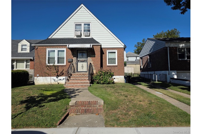 Bungalow with brick siding a 4 car driveway