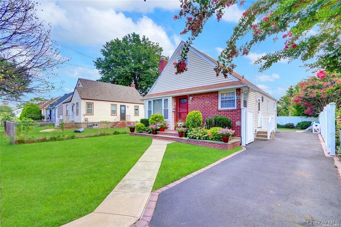 Bungalow-style house featuring brick siding and a chimney