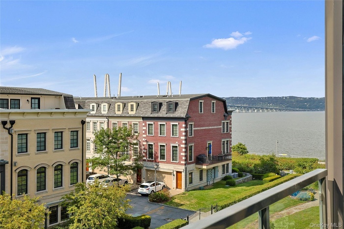 View of property with a water view and bridge