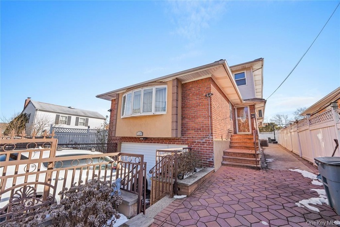 View of front of home with brick siding and a garage