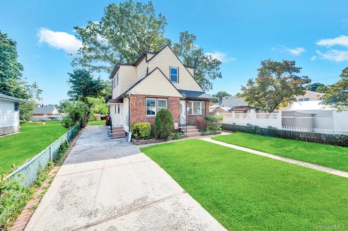 Bungalow with brick siding and concrete driveway
