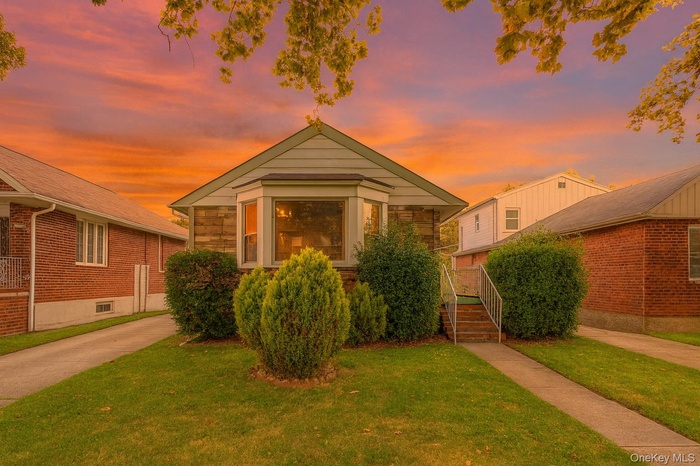 View of front of property with a yard
