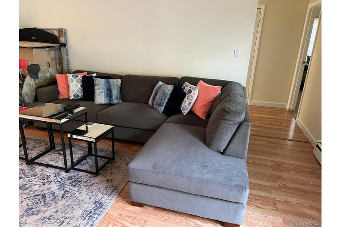 Living area featuring light wood-style flooring and baseboards