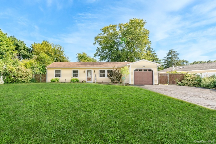 Single story home featuring concrete driveway