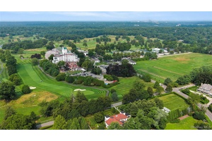 Iconic and admired Westchester Country Club gem on prime double lot with breathtaking views of golf course and main clubhouse.