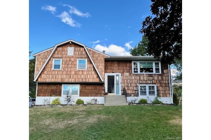 Beautifully updated residence featuring newly installed cedar shakes on the front exterior—adding timeless warmth and character to the home’s curb app
