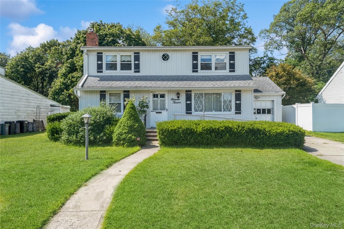 Front of house with a chimney and a shingled roof