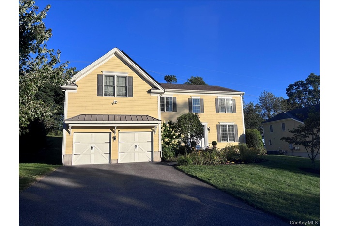 Front facade view with attached two car garage