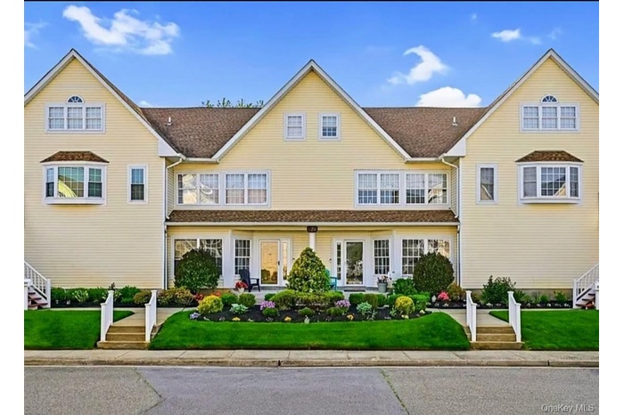 Traditional-style house with stairway and a front lawn