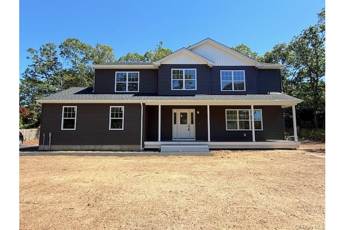 View of front of house featuring a porch and a shingled roof
