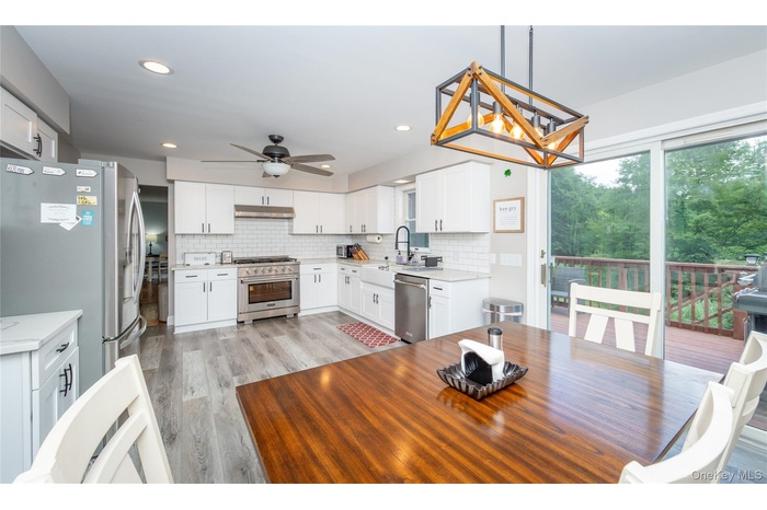 Dining room with a ceiling fan, light wood-style floors, and recessed lighting