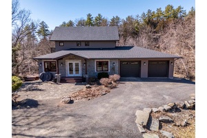 Perched atop the hillside, adorned in Canadian Shield outcroppings, on highly coveted Buck Lake, sits this stunning custom built stone amp ; stucco masterpiece awaiting its proud new owner.
