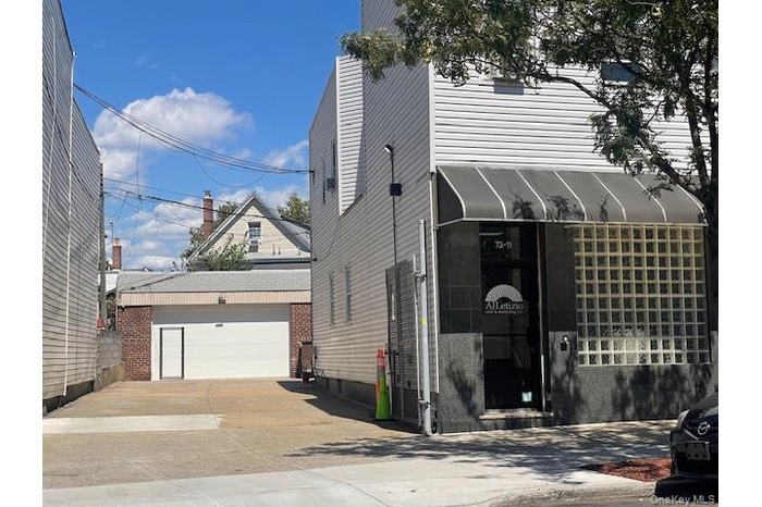 View of property exterior with an outdoor structure